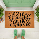 New Year welcome doormat featuring 12 new chapters 365 new chances text on a natural coir fiber mat, placed on a front porch entryway with green sneakers visible, perfect for a seasonal home decor entrance or housewarming front