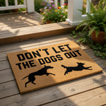 Funny dog doormat with the text Don't Let The Dogs Out and silhouettes of two running dogs, this natural coir fiber welcome mat is a humorous front porch decor piece for pet owners and dog lovers looking for a unique entryway rug.