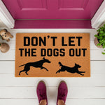Don't Let The Dogs Out doormat featuring black dog silhouettes on a natural coir fiber welcome mat, perfect for a pet lover front porch decor, funny dog themed entry rug for home entrance, and durable outdoor floor mat for dog