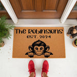 Personalized monkey family doormat featuring a cute primate illustration and custom text on a natural coir welcome mat, perfect for a front porch entrance or housewarming gift for a new home with a fun animal theme.