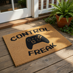 Control Freak gaming doormat with a black video game controller graphic on a natural coir fiber welcome mat, perfect for a gamer room entrance or front door decor for those who love playing console video games at home.