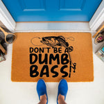 Funny fishing doormat with a bass fish graphic and text that reads Don't Be A Dumb Bass, featuring a natural fiber welcome mat design for a front porch that makes a humorous gift for fishermen and outdoor enthusiasts who love