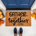 Gather Together fall doormat featuring black script text and pumpkin leaf designs on a natural coir welcome mat, perfect for autumn porch decor, front door entryways, and seasonal home entrance styling for a cozy harvest look.