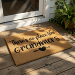 Grandma doormat featuring a natural coir fiber welcome mat design with black text that reads There is no place like Grandma's and a heart arrow icon, perfect for a front porch entry rug or a personalized housewarming home decor