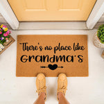 Grandma doormat with a natural fiber texture and black text reading There is no place like Grandma's, featuring a heart and arrow design on this outdoor welcome mat placed at a front door entrance for a cozy home decor look.