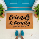 Friends and family gather here coir doormat featuring black script text on a natural fiber welcome mat, placed on a porch in front of a blue door with potted ferns, perfect for a farmhouse entryway or a stylish home entrance