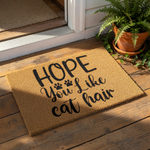 Funny cat hair doormat with black text on a natural coir fiber welcome mat, featuring a humorous quote for cat lovers and pet owners, perfect for a front porch entrance or home decor for feline enthusiasts and indoor cat