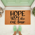 Funny cat hair doormat for pet lovers, featuring a natural coir welcome mat with black text and paw prints, placed on a front porch as a humorous entryway rug for cat owners who want a cute and durable outdoor floor mat for their