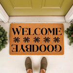 Funny welcome goodbye doormat with snowflake design on a natural coir fiber mat, placed at a front door entrance for a humorous home decor look that greets guests and says goodbye as they leave your house with this unique floor