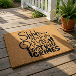 Funny TV crime show doormat with a natural coir texture and black text that reads Shhh I am busy solving TV crimes, making this a humorous welcome mat for true crime fans and a unique front porch decor piece for your home