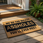 Funny doormat with rude text on a porch, this natural coir welcome mat features bold black lettering that says we are the nicest assholes you will ever meet, making it a hilarious front door rug for a home with a sarcastic sense