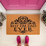 Best DM Dad Ever doormat featuring a twenty-sided die icon on natural coir fiber, this funny tabletop gaming welcome mat is a unique housewarming decor piece for a fantasy roleplaying game fan and his front porch entryway.