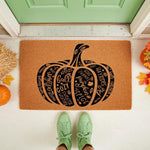 Fall pumpkin welcome doormat featuring seasonal words like apples, sweater weather, and pumpkin spice on a natural coir fiber mat, placed on a front porch with autumn decor for a festive seasonal home entrance and outdoor floor