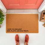 Funny coir doormat for front porch entry featuring the text I hope you brought beer, plants, and dog treats, displayed on a white floor with orange sneakers in view, perfect as a humorous welcome mat for dog lovers and plant