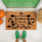 Funny witch Halloween doormat featuring Good Witch Bad Witch text on natural coir fiber, perfect for fall porch decor with pumpkins and hay, this outdoor welcome mat adds a spooky seasonal touch to your front door entryway