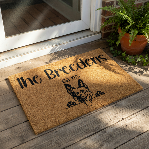 Personalized German Shepherd doormat featuring a custom family name and established year on a natural coir welcome mat, perfect for dog lovers looking for a durable outdoor front porch rug with a cute canine illustration.