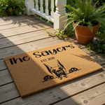Personalized Doberman doormat featuring a custom family name and established year on natural coir fiber, this durable outdoor welcome mat showcases a cute dog peeking over the edge for a unique pet lover home entrance decor piece.