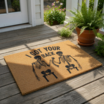 Skeleton I Got Your Back doormat featuring two black skeletons fist bumping on a natural coir fiber welcome mat, a funny gothic home decor floor rug for front porch entryways that makes a unique housewarming or spooky holiday