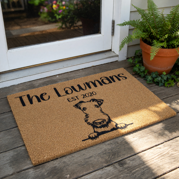 Personalized family name coir doormat featuring a cute terrier dog illustration, this custom welcome mat is a durable outdoor floor rug for your front porch entry that makes a charming housewarming or wedding home decor piece.