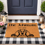 Personalized dog breed doormat featuring a custom family name and year on natural coir fiber, displayed on a porch with a buffalo check rug, lanterns, and greenery for a stylish outdoor entryway decor look for pet lovers.