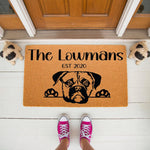 Personalized Pug dog doormat featuring a cute puppy face illustration, custom family name, and established year on natural coir fiber, perfect for a front porch entryway or as a unique housewarming welcome mat for dog lovers.