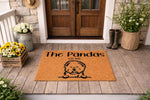 Personalized dog breed doormat featuring a cute fluffy puppy illustration on a natural coir welcome mat, perfect for a front porch entryway decor, custom family name floor rug, and durable outdoor entrance mat for pet lovers.