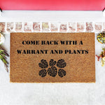 Funny plant lover doormat with the text Come Back With A Warrant And Plants, featuring monstera leaf designs on natural coir fiber.
