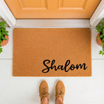 Shalom coir doormat for front porch entry, featuring a natural fiber welcome mat with black script text.