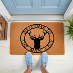 Man Cave welcome doormat featuring a black deer head silhouette in a circular design on natural coir fiber, perfect for a garage, basement, or home entrance floor mat decor for a rustic hunting themed room or housewarming