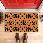 Winter snowflake doormat with a natural coir fiber texture and black printed snowflake patterns, perfect for a festive holiday porch decor entrance mat or a seasonal welcome mat for your home front door during the cold winter