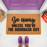 Funny Go Away Unless You Are The DoorDash Guy doormat for front porch entry, featuring bold black text on a natural coir fiber welcome mat, perfect for food delivery fans and home decor enthusiasts looking for a humorous entryway