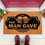 Man Cave doormat with beer mug design, a natural coir fiber welcome mat for home bar or garage decor, featuring a bold black graphic of clinking beer steins on a durable outdoor floor rug for a basement, den, or man cave entrance.