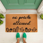 Funny cactus doormat with the text no prichs allowed, featuring a natural coir fiber welcome mat design with black ink illustrations of desert plants placed on a front porch for a humorous home entrance decor look.