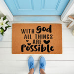 Religious welcome doormat featuring the phrase With God All Things Are Possible in black text on a natural coir fiber mat, placed on a white porch in front of a blue door, perfect for faith-based home decor and entryway floor