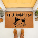 Personalized cat welcome doormat featuring a cute kitten illustration and custom family name text on a natural coir fiber mat, perfect for a front porch entryway, housewarming decor, or a cat lover home entrance floor rug.