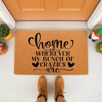 Funny family doormat with the text Home is wherever my bunch of crazies are, featuring a natural coir fiber welcome mat design for a front porch entrance, perfect for a humorous housewarming decor style for your home entryway.