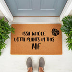 Funny plant lover doormat with a monstera leaf design and bold text reading Issa Whole Lotta Plants In This MF, perfect for a houseplant enthusiast entryway, this natural coir fiber welcome mat adds humor to your front porch