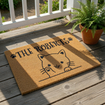 Personalized cat doormat featuring a cute kitten illustration and custom family name text on a natural coir welcome mat, perfect for cat lovers looking for a durable outdoor front door rug or a unique housewarming entryway floor