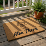 Aloe There coir doormat featuring a cute potted plant illustration, this natural fiber welcome mat is a funny housewarming entry rug for plant lovers who want a stylish front porch decor piece for their home entrance.