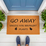 Funny plant lover doormat with Go Away Unless You Brought Plants text and leaf icons, featuring a natural coir fiber welcome mat on a white porch floor in front of a blue door, perfect for housewarming decor or a unique entryway