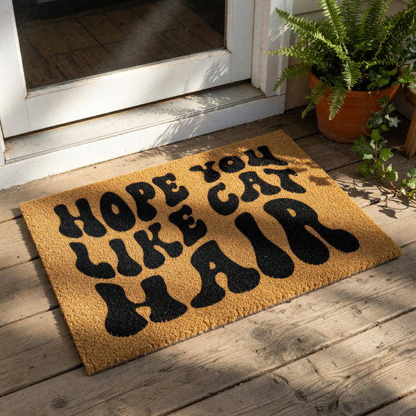 Hope You Like Cat Hair coir doormat with funny typography, a natural fiber welcome mat for pet owners that features bold black text on a textured brown surface, perfect for a front porch or entryway decor for cat lovers.