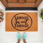 Home Sweet Home pet lover doormat with paw print accents, featuring a natural coir fiber welcome mat design on a front porch, perfect for dog owners looking for a stylish outdoor rug to decorate their entryway and greet house