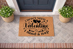 Funny Valentine doormat with I don't need a Valentine I need a nap text, featuring black script on a natural coir welcome mat placed on a gray brick porch, perfect for seasonal home decor and humorous entryway floor mat styling.