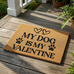My Dog Is My Valentine doormat featuring black text and paw prints on a natural coir fiber welcome mat, perfect for pet lovers celebrating the holiday with a cute dog themed front porch decor piece for your home entrance.