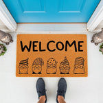 Gnome welcome doormat featuring five cute illustrated gnomes in patterned hats on a natural coir fiber mat, perfect for a front porch entry way decor, outdoor floor rug, or housewarming entrance mat for a whimsical home style.