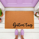 Guten Tag coir doormat featuring a natural fiber welcome mat design with black script text, perfect for a front porch entryway, housewarming decor, or a stylish outdoor floor rug for your home entrance and doorstep.