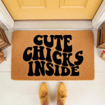 Cute Chicks Inside doormat featuring bold black typography on a natural coir fiber welcome mat, placed at a front door entrance for a funny farmhouse porch decor look that adds personality to your home entryway and outdoor floor