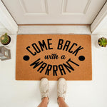 Funny Come Back With A Warrant doormat featuring bold black text on a natural coir fiber welcome mat, perfect for a front porch entry, housewarming decor, or a humorous home entrance rug that adds personality to your front door.