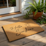 Hello Sunshine coir doormat with a natural fiber texture and black script lettering, featuring a sun icon design for a front porch welcome mat that adds a cheerful look to your home entryway decor and outdoor floor covering.