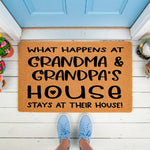 Grandma and Grandpa house doormat featuring funny text on a natural coir fiber welcome mat, placed on a white porch floor in front of a blue door, making a humorous home decor entrance rug for grandparents and their visiting